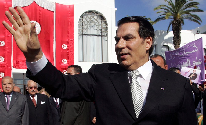 Tunisia's President Zine al-Abidine Ben Ali waves to supporters after he took the oath at the national assembly in Tunis Nov. 12, 2009