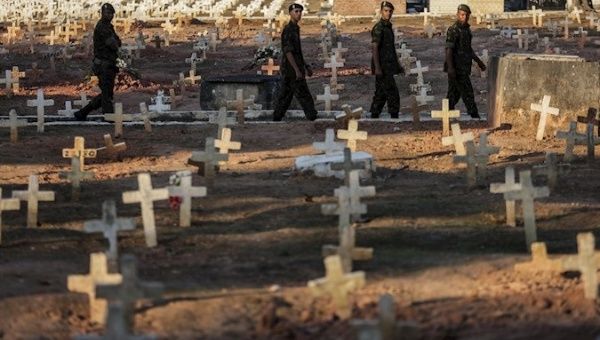 Members of Brazilian security forces cross a cemetery located at an urban poor neighborhood, Brazil, Sep. 10, 2019.