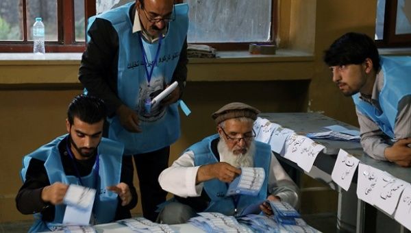 Afghan election commission workers count ballot papers of the presidential election in Kabul, Afghanistan September 28, 2019. 