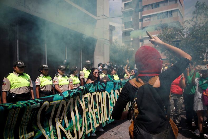 Women with green smoke in front of the attorney general’s office in Quito, Ecuador. 