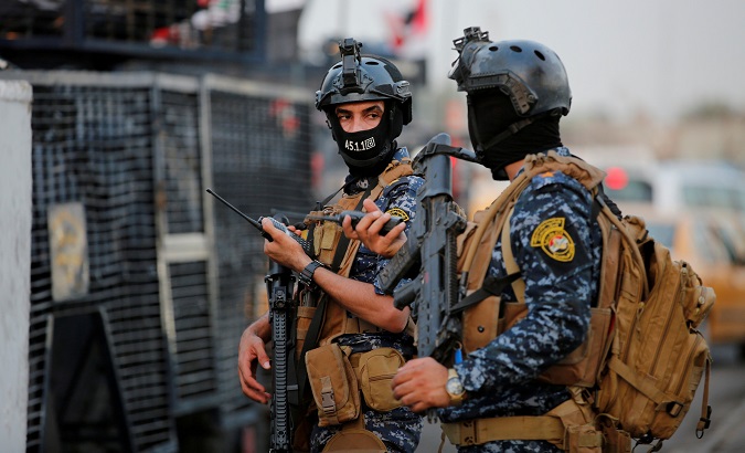 Members of Iraqi federal police are seen with military vehicles in a street in Baghdad, Iraq October 7, 2019.