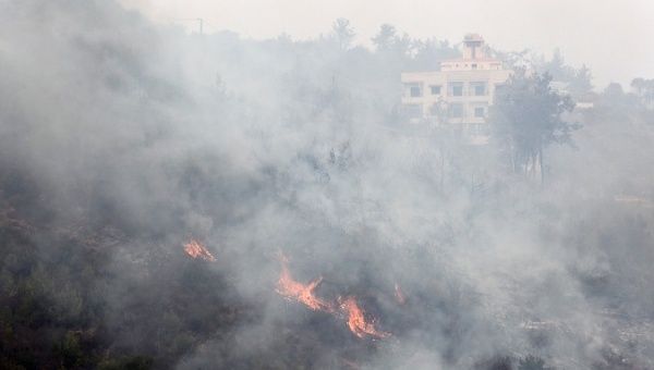 Wildfires burn near properties in Dibbiyeh village, south of Beirut, Lebanon October 15, 2019.