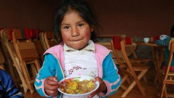 In 2019, a girl eats lunch in the Hanaq Chuquibamba community in Peru.