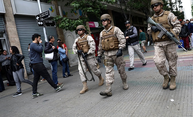 Soldiers patrol streets after a protest against the increase in subway ticket prices in Santiago, Chile, October 19, 2019.