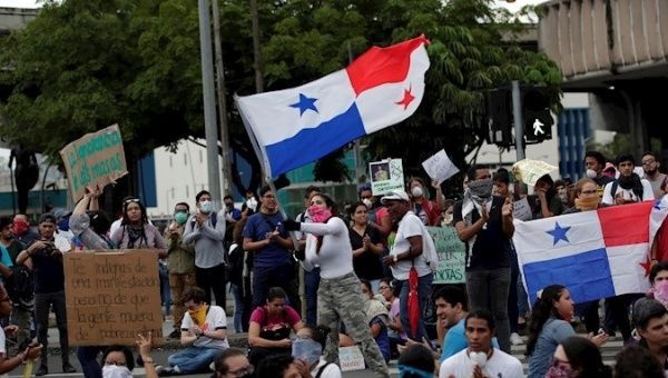 A protester flies a Panama flag during a student protest in front of the National Assembly in Panama City, Panama, Oct. 31, 2019.
