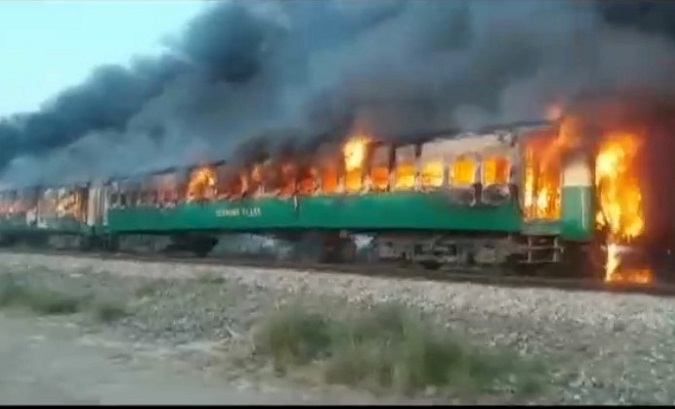 A fire burns a train carriage after a gas canister passengers were using to cook breakfast exploded, near the town of Rahim Yar Khan in the south of Punjab province, Pakistan October 31, 2019, in this still image take from video.