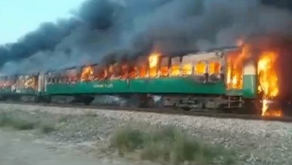 A fire burns a train carriage after a gas canister passengers were using to cook breakfast exploded, near the town of Rahim Yar Khan in the south of Punjab province, Pakistan October 31, 2019, in this still image take from video. 