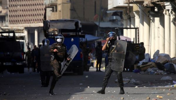 Members of riot police gesture as they clash by demonstrators during the ongoing anti-government protests in Baghdad, Iraq November 7, 2019.