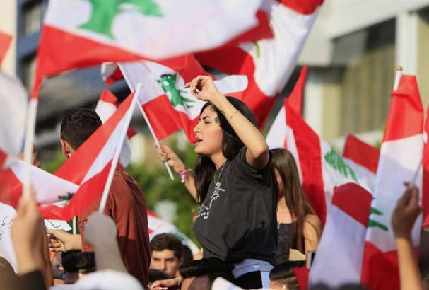 Demonstrators hoisting the Lebanese flag demanded the fall of the government