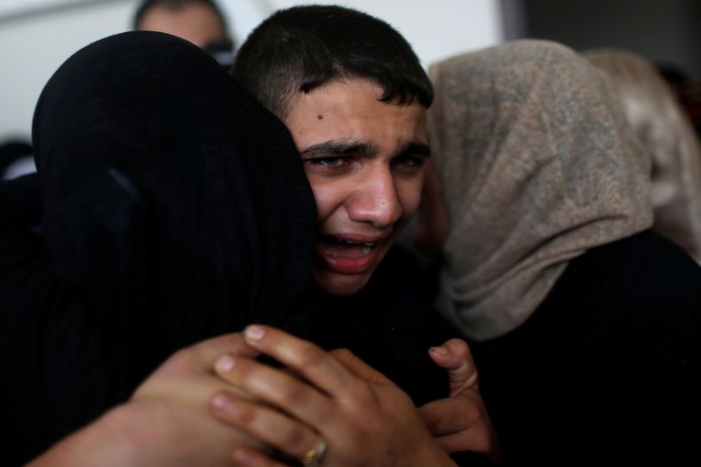The son of Palestinian Islamic Jihad field commander Baha Abu Al-Atta mourns during his father's funeral in Gaza City November 12, 2019.