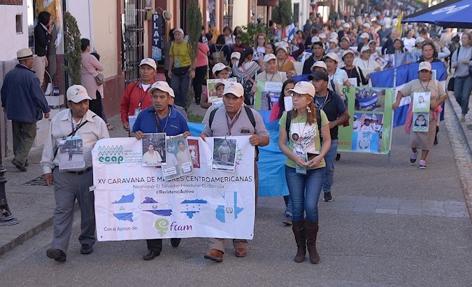 Central American mothers hold photographs of their missing migrant children during a march in San Cristobal de Las Casas, Chiapas, Mexico, Nov. 20, 2019.