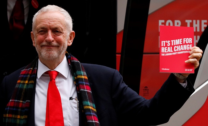 Labour Party leader Jeremy Corbyn holds his party's general election manifesto in Birmingham, Britain Nov. 21, 2019.