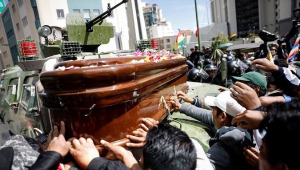 People place the coffin of a person killed by security forces on top of an armored vehicle in La Paz, Bolivia Nov. 21, 2019.