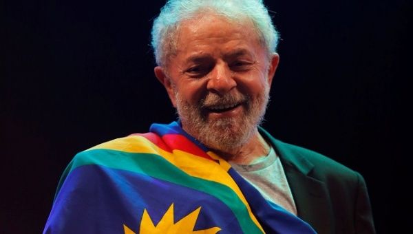 Lula da Silva is draped in the flag of the Pernambuco State in Recife, Brazil, Nov. 17, 2019. 