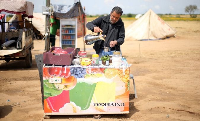 A Palestinian man sells tea and coffee during a tent city protest at Israel-Gaza border, in the southern Gaza Strip April 3, 2018. Picture taken April 3, 2018.