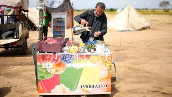 A Palestinian man sells tea and coffee during a tent city protest at Israel-Gaza border, in the southern Gaza Strip April 3, 2018. Picture taken April 3, 2018. 