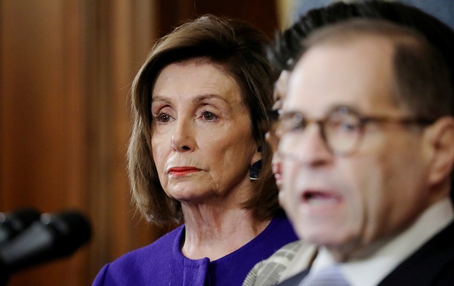 U.S. Speaker of the House Nancy Pelosi (D-CA) listens as House Judiciary Committee Chairman Jerrold Nadler speaks about articles of impeachment against Preisdent Donald Trump during a news conference with other Democratic committee chairs to announce artiicles of impeachment against the president on Capitol Hill in Washington, U.S., December 10, 2019.