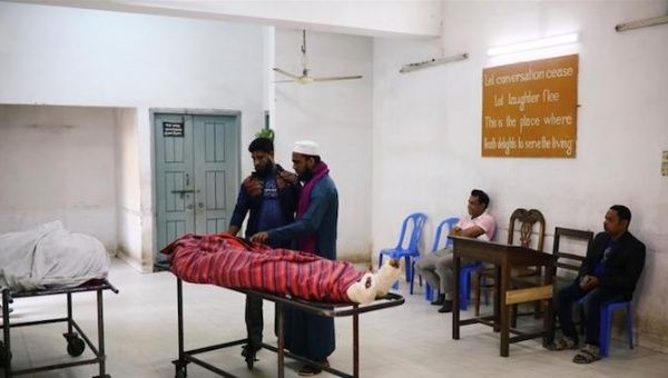 In this file photo, relatives are seen at the morgue of Dhaka Medical College Hospital after a deadly fire in a plastic factory near Dhaka in Bangladesh last week.