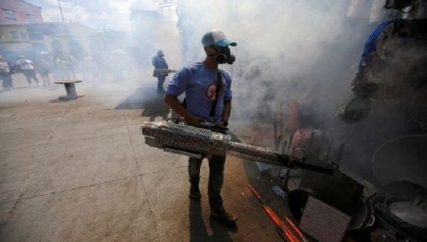 Municipal worker fumigates a market to prevent the spread of dengue fever in Tegucigalpa, Honduras, July 25, 2019.