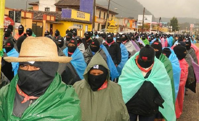 Dressed in green and brown uniforms, red scarves and ski masks, the Zapatistas paraded to the community of Morelia