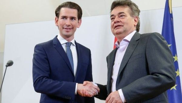 Leader of Austria's Green Party Werner Kogler and head of People's Party (OeVP) Sebastian Kurz shake hands after delivering a statement, in Vienna, Austria Jan. 1, 2020. 