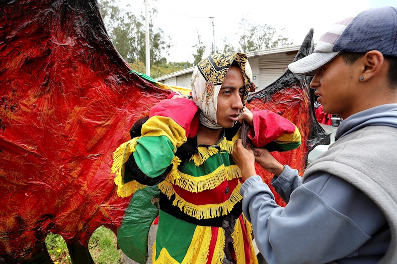 Young people prepare their outfits to dance in this Andean carnival, Pillaro, Ecuador, January 3, 2020.