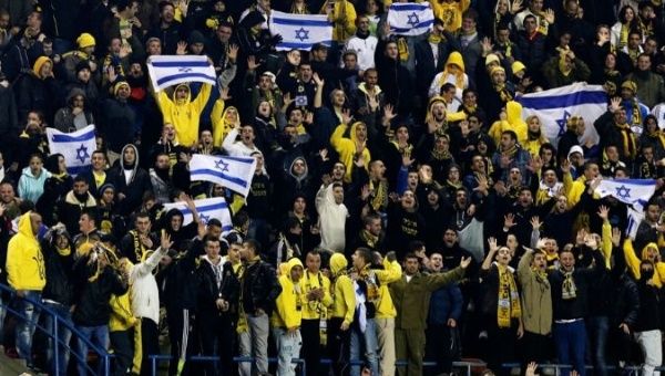 Supporters of Beitar Jerusalem cheer for their team during a soccer match against Maccabi Umm el-Fahm at Teddy Stadium in Jerusalem Jan. 29, 2013. 