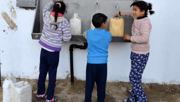 Palestinian children fill buckets with drinking water from China-funded water desalination plants in al-Naser village in the Gaza Strip's southern border town of Rafah, on Jan. 8, 2020. 