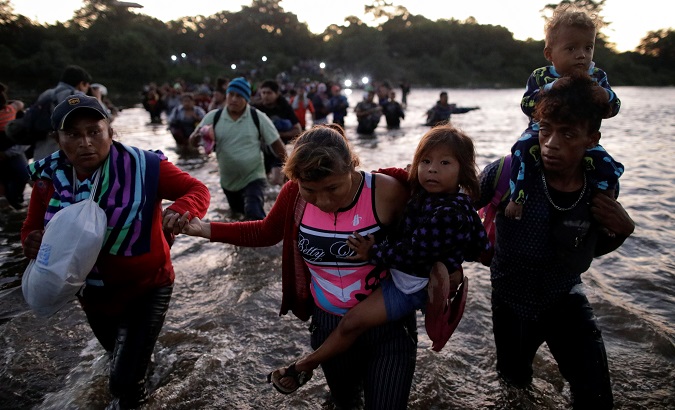 Migrants marching in a caravan cross the Suchiate river on the outskirts of Hidalgo city, Mexico, Jan. 23, 2020.