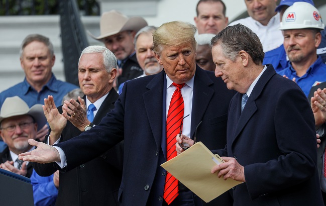 U.S. President Donald Trump talks with U.S. Trade Representative Robert Lighthizer as Vice President Mike Pence applauds during a signing ceremony for the United States-Mexico-Canada Trade Agreement (USMCA) on the South Lawn of the White House in Washington, U.S., January 29, 2020.