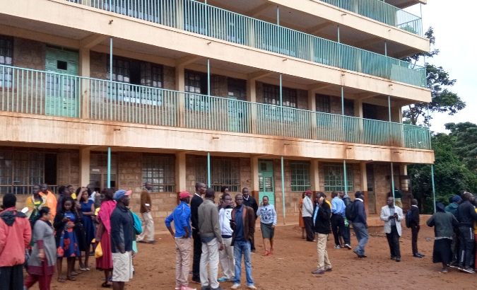 Parents and teachers gather near the scene of a stampede at the Kakamega primary school in Kakamega, Kenya Feb. 3, 2020.