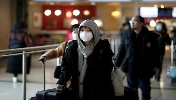 Tourists from an Air China flight from Beijing wear protective masks as they arrive at Charles de Gaulle airport in Paris, France, January 26, 2020.