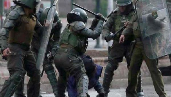 Military police hit a student to the ground, Santiago, Chile, 2020.