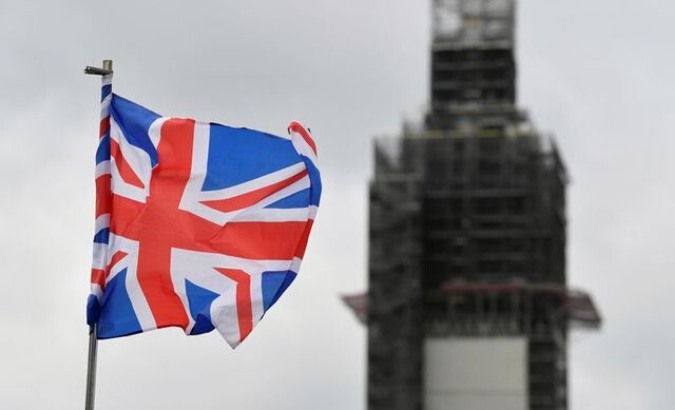A Union Jack flag flutters as Big Ben clock tower is seen behind at the Houses of Parliament in London, Britain September 11, 2019.