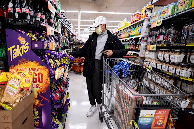 A customer shops wearing a face mask in a neighborhood supermarket amid coronavirus pandemic in Los Angeles, California