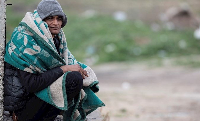 A migrant rests near the Turkish-Greek border in Edirne, Turkey, March 10, 2020.