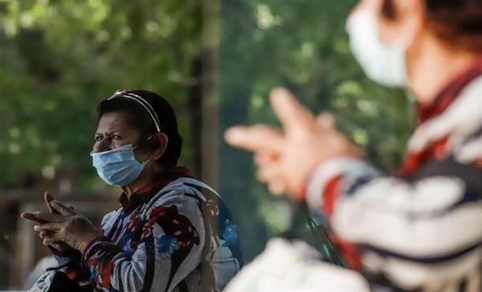 A woman with a mask hopes to enter a private clinic in Asunción, Paraguay, April, 2020.