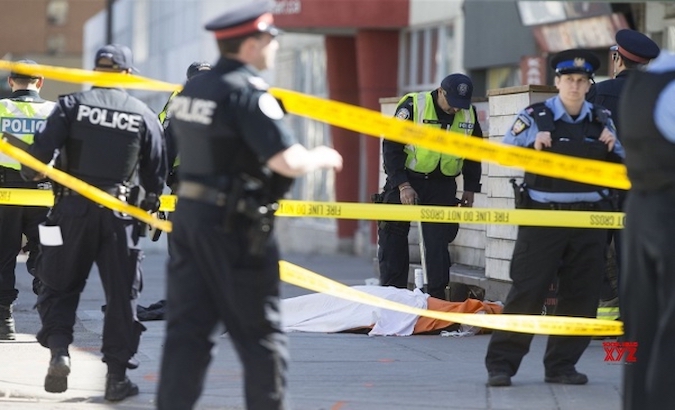 Paramedics and police officers surround one of the victims left by the killer in Nova Scotia, Canada, April 19, 2020.