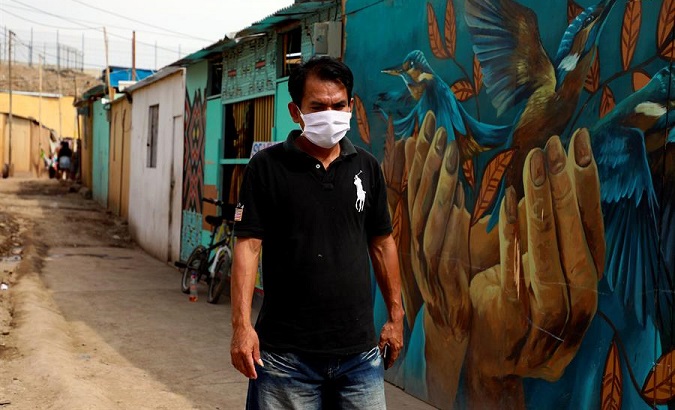 Person walks in the Shipibo Konibo slum, Lima, Peru, March 31, 2020.