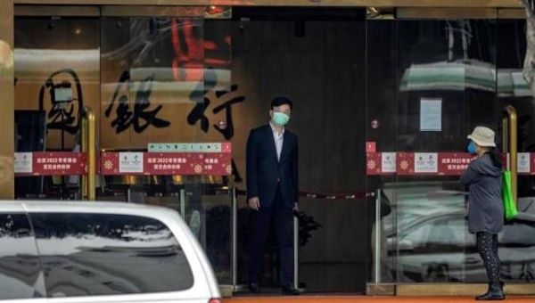 A man walks through the exit door of a company in Wuhan, Hubei, China, April 26, 2020. 