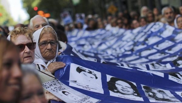 Citizens carry a banner with the photos of those disappeared by the dictatorship, Argentina, 2017.