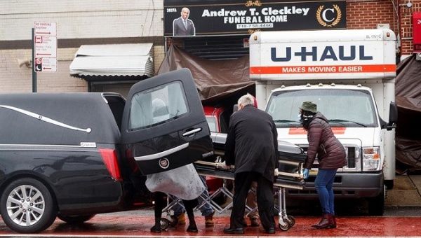 A casket is placed in a hearse in Brooklyn, New York, USA, April 30, 2020. 