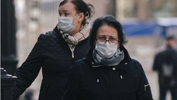Women wearing face masks walk on a street in Moscow, Russia, on April 30, 2020.