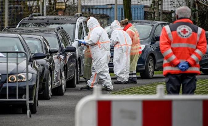 Paramedics collect swab samples from car drivers to be tested for coronavirus. Oberhausen, Germany, March 19, 2020.