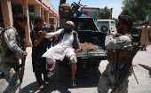 Security officials shift injured victims of a suicide bomb attack to a hospital, Jalalabad, Afghanistan, May 12, 2020. 