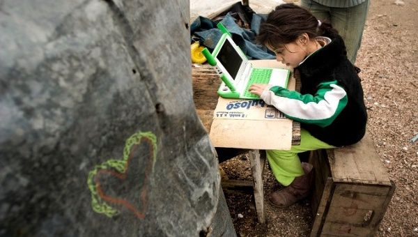 A children studies at home with a laptop in Uruguay on May 20, 2020.