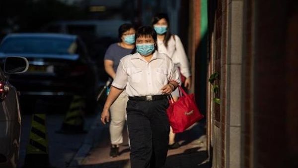 People walk the streets of Wuhan, the Chinese city where the new coronavirus originated in 2019. May, 2020.