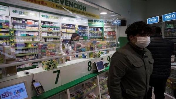 Customers visit a pharmacy in downtown Santiago, Chile, May 30, 2020.