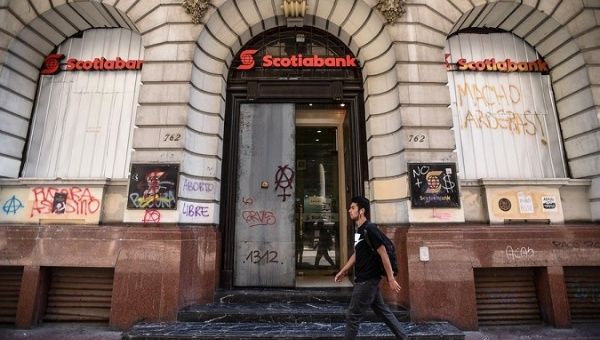 A protester passes by a bank during 2019 demonstrations in Santiago, Chile.