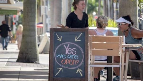 A sign outside a coffee shop reads, 
